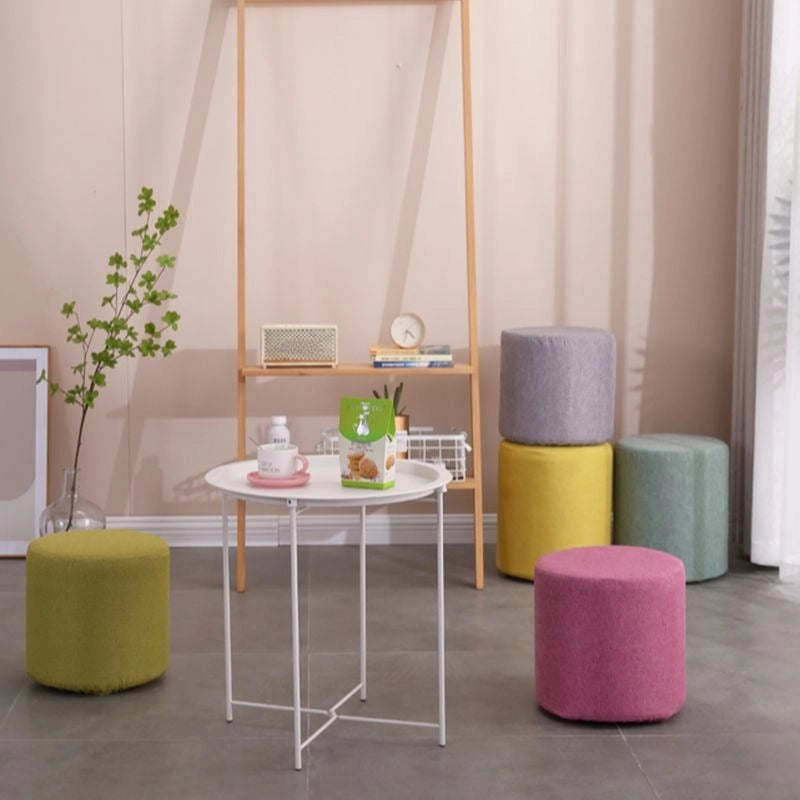 The Sierra pouffe is a soft-seated cylindrical ottoman designed for comfort and compact utility.