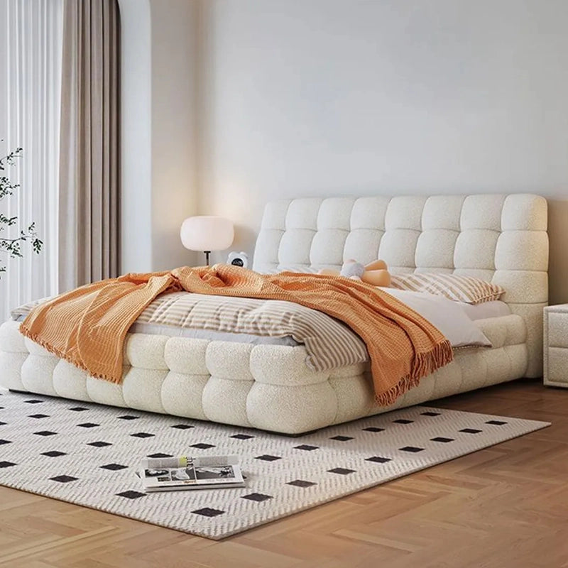 Biscuit tufted headboard image with modern bed design and bed frame in ivory boucle