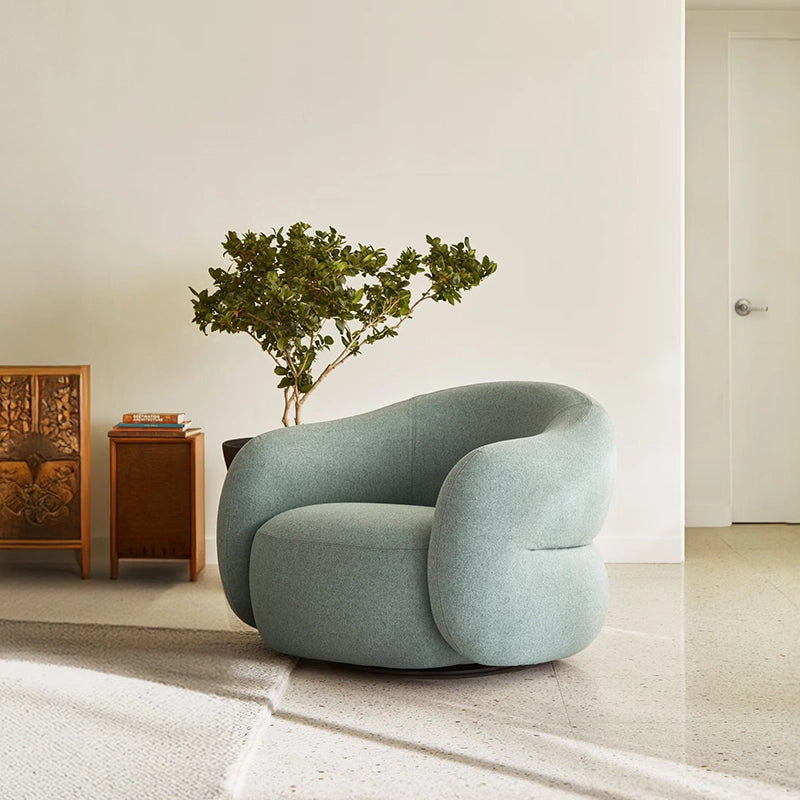Rounded armchair silhouette, lounge room chair and comfort chair, fabric upholstery, hidden base