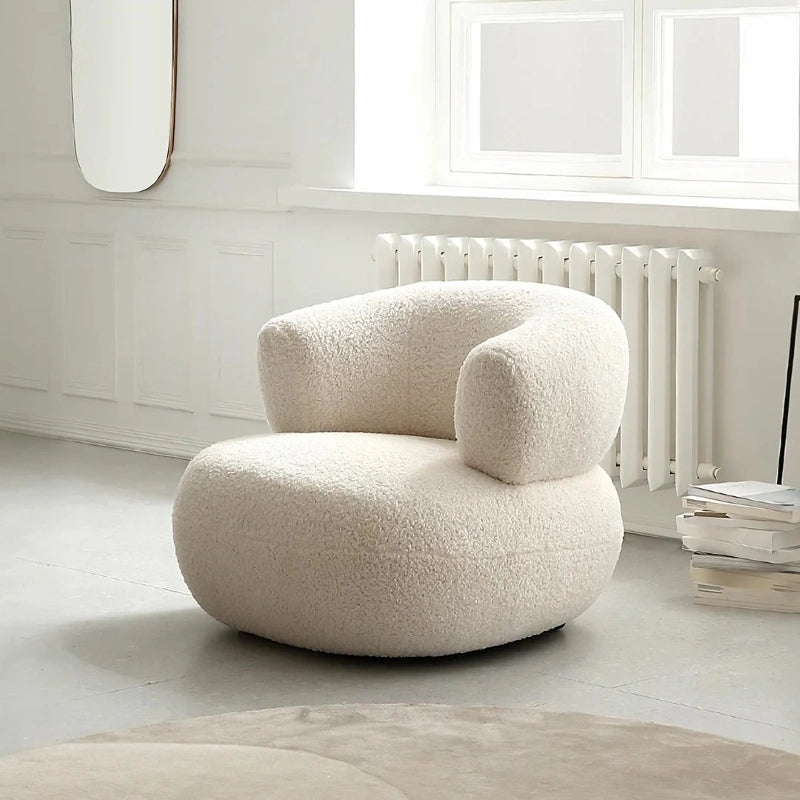 Rounded chair design in ivory fabric with soft one seater sofa chair shape and comfort chair build