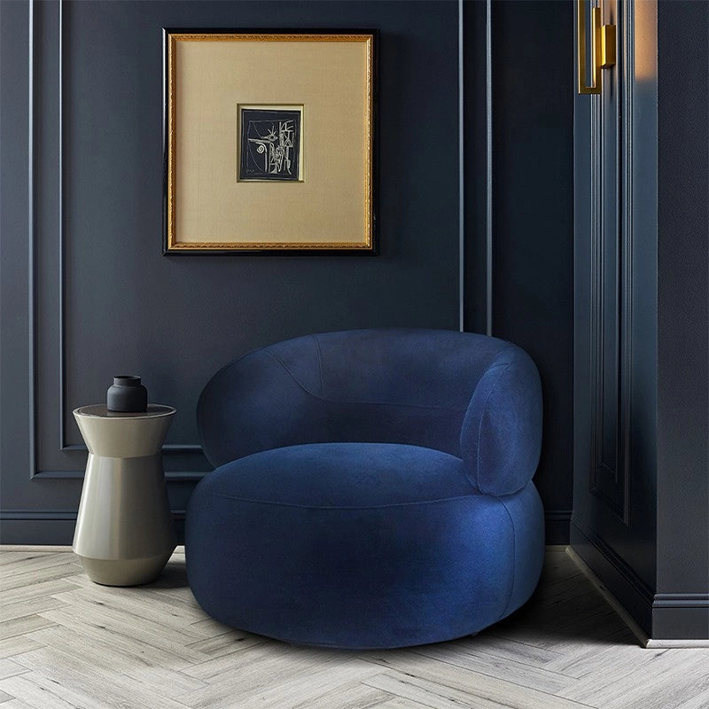 Sculptural sofa armchair with comfort chair appeal in deep blue velvet finish