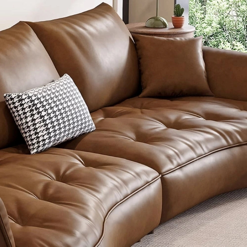 Rounded wooden legs and asymmetrical silhouette – stylish sofa design + premium sofa + leather + tan