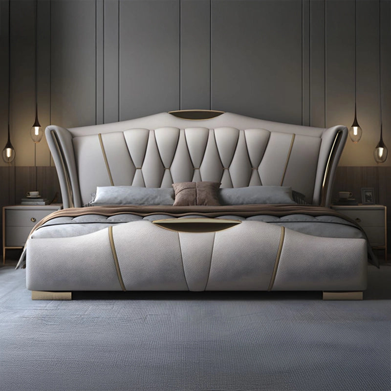 King size upholstered bed featuring beige leatherette upholstery, luxury wingback headboard, vertical tufting, gold accents and contemporary modern bed frame design