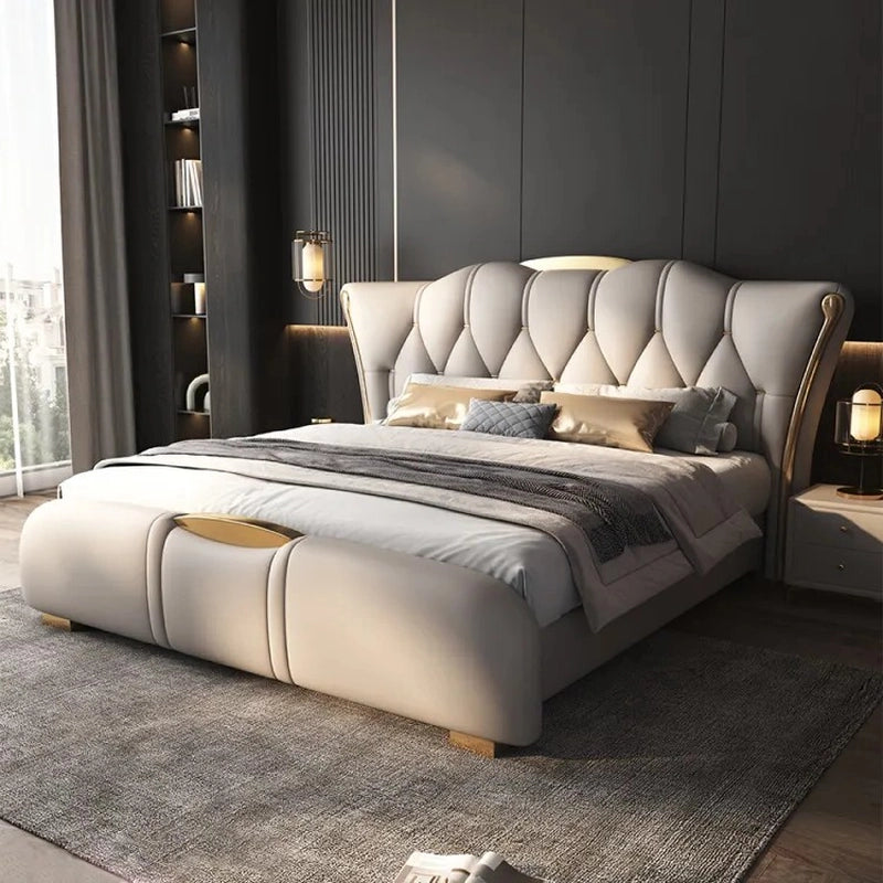 King size upholstered bed featuring leatherette upholstery, scalloped diamond tufted headboard, gold-tipped legs and luxury modern bed frame design