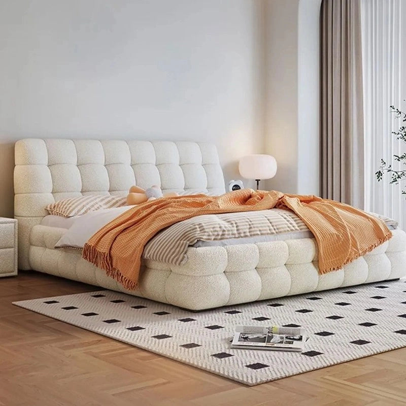 King size upholstered bed featuring biscuit tufted headboard and footboard, plush cushioning and contemporary modern bed frame design