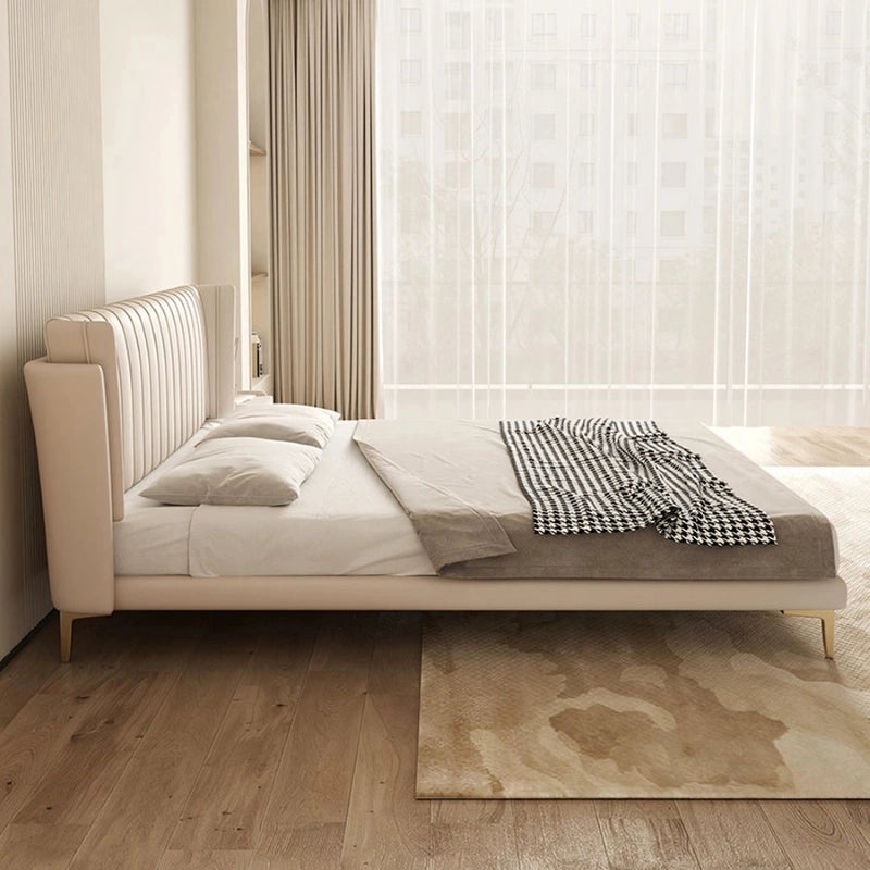 King size upholstered bed featuring a vertical channel tufted wingback headboard, faux leatherette upholstery and modern bed frame appeal