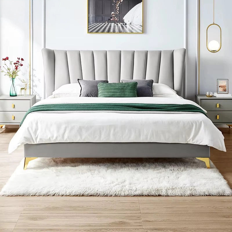 Queen size upholstered bed featuring a velvet wingback headboard, gold-tipped metal legs and modern upholstered cot design for contemporary bedrooms