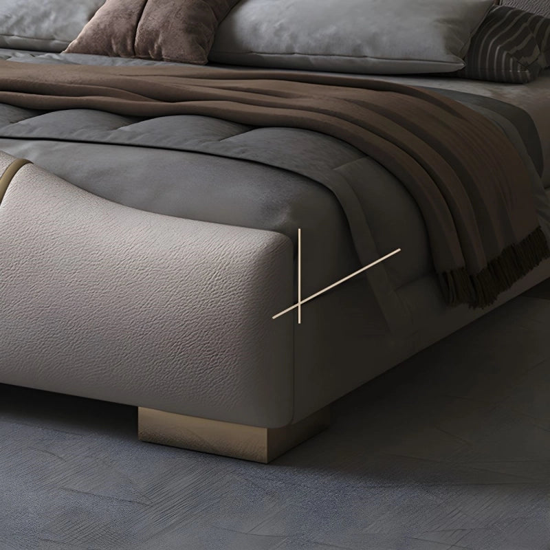 Spear bed for king size mattress with upholstered bed construction, curved footboard, gold trim detail and elegant master bedroom bed design