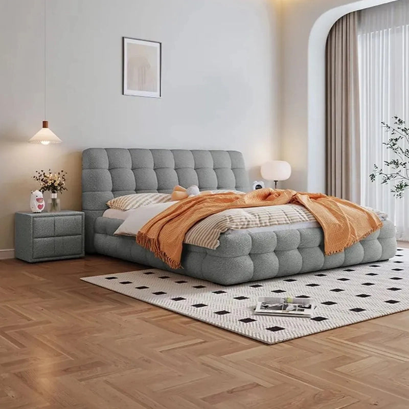 Pelican upholstered bed with king size bed comfort, plush platform bed design, biscuit tufted headboard and elegant master bedroom styling
