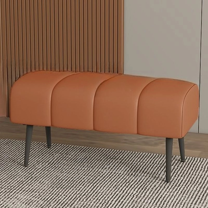 Its smooth faux leather upholstery comes in warm tones like tan, beige, and orange—ideal for blending into contemporary living rooms, entryways, or dressing areas