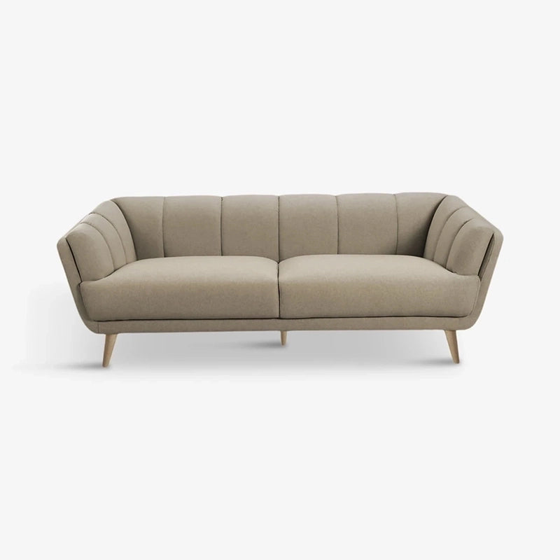 Available in 2 seater and 3 seater sofa variants, it showcases a straight profile with inward-curved armrests and plush, fixed cushions stitched in elegant vertical channels.