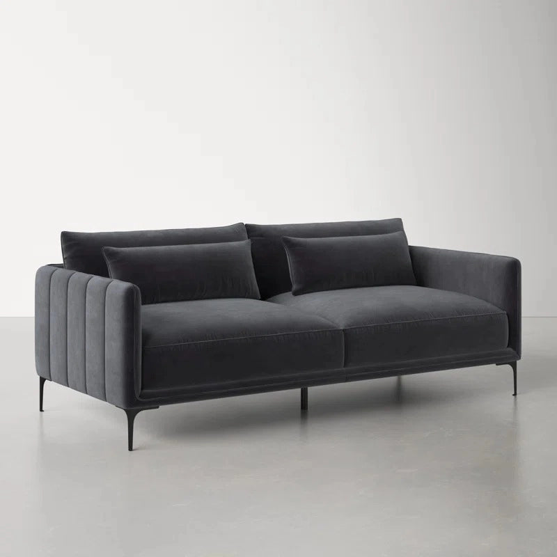 Soft velvet and faux leather options are enhanced by slender black legs and vertical channel tufting.
