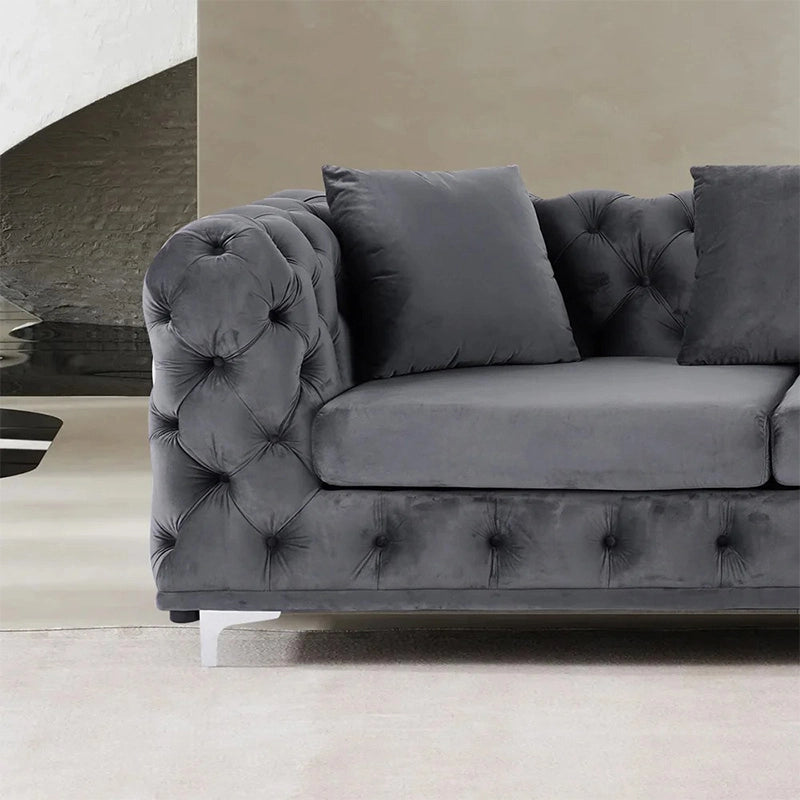 Available in tones like taupe and charcoal, the settee balances visual drama with ergonomic form.