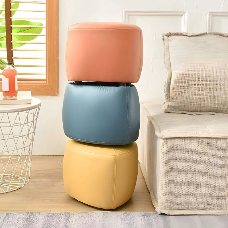 The Oleander pouffe ottoman blends form and function through a geometric triangle shape and soft leatherette upholstery in contemporary pastel tones