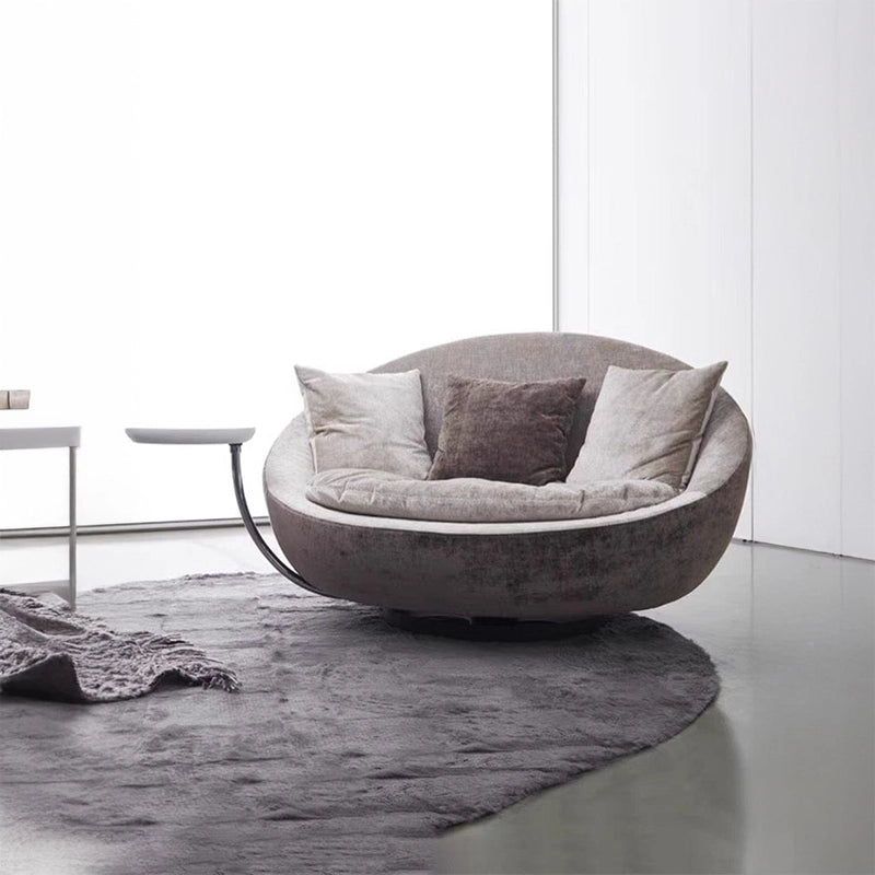 The bowl-shaped silhouette adds grounded visual weight, while the ergonomic build with soft back cushions supports extended lounging