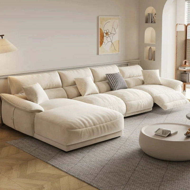 Its smooth, piped edges and pillow-top arms enhance its soft aesthetic, while concealed legs maintain a ground-hugging look