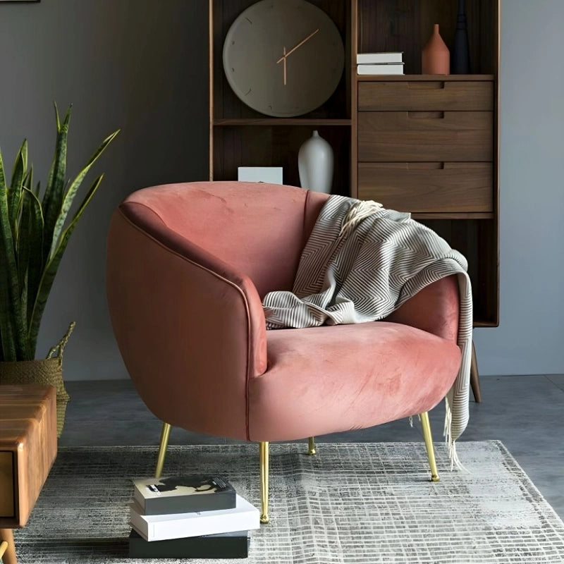 With its sculpted barrel back, curved shelter arms, and gold-finished tapered legs, it adds visual lightness to contemporary interiors.