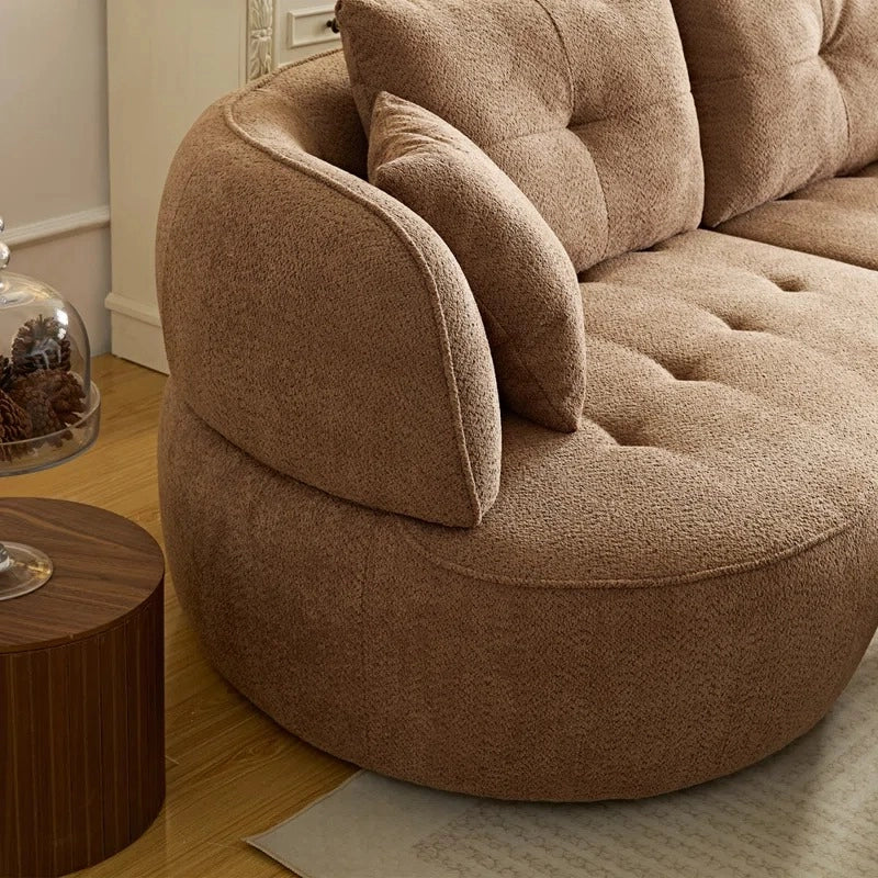 Front perspective view of Selestial curved sofa featuring rounded profile, luxury sofa comfort, modern sofa styling and elegant living room sofa aesthetics