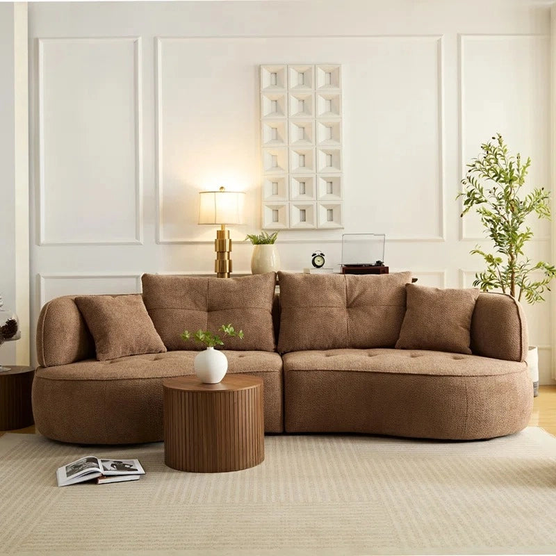 Upholstered in earthy shades like rust, ivory, and taupe, it adapts well across decor styles. 