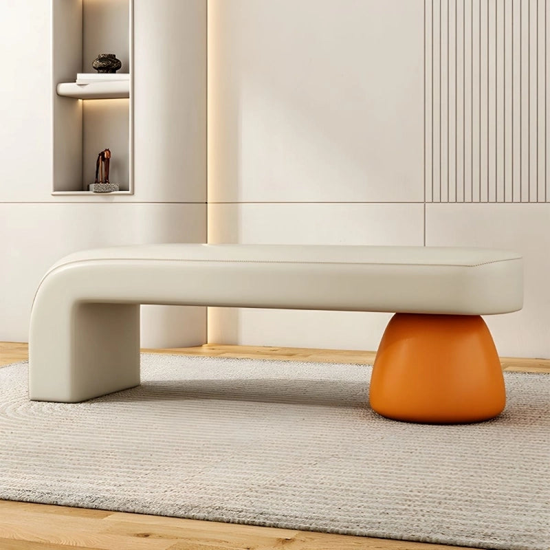 Pebble-shaped leg base, ottoman bench style with backless profile in mustard fabric