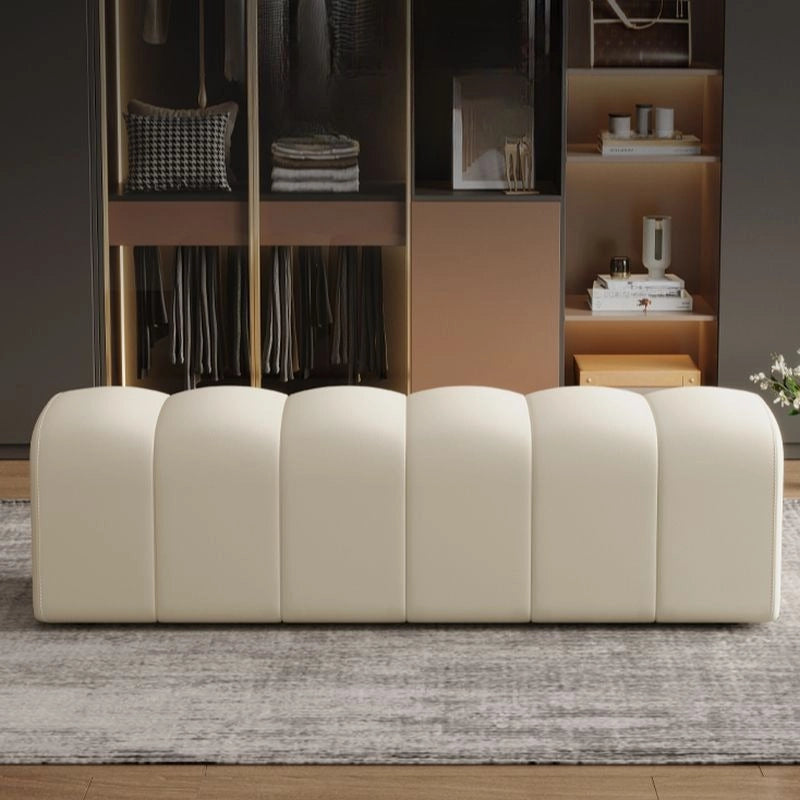 The Cassia bench presents a rectangular, backless design crafted with plush vertical channelling and rounded edges. 
