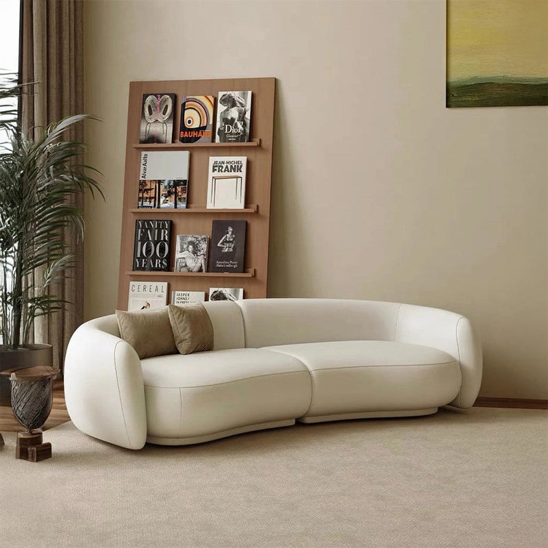 Creamy white kidney sofa designed as a premium 3 seater sofa featuring a leather sofa finish, luxury couch styling, luxury sofa comfort, and modern lounge sofa appeal for elegant living room interiors.