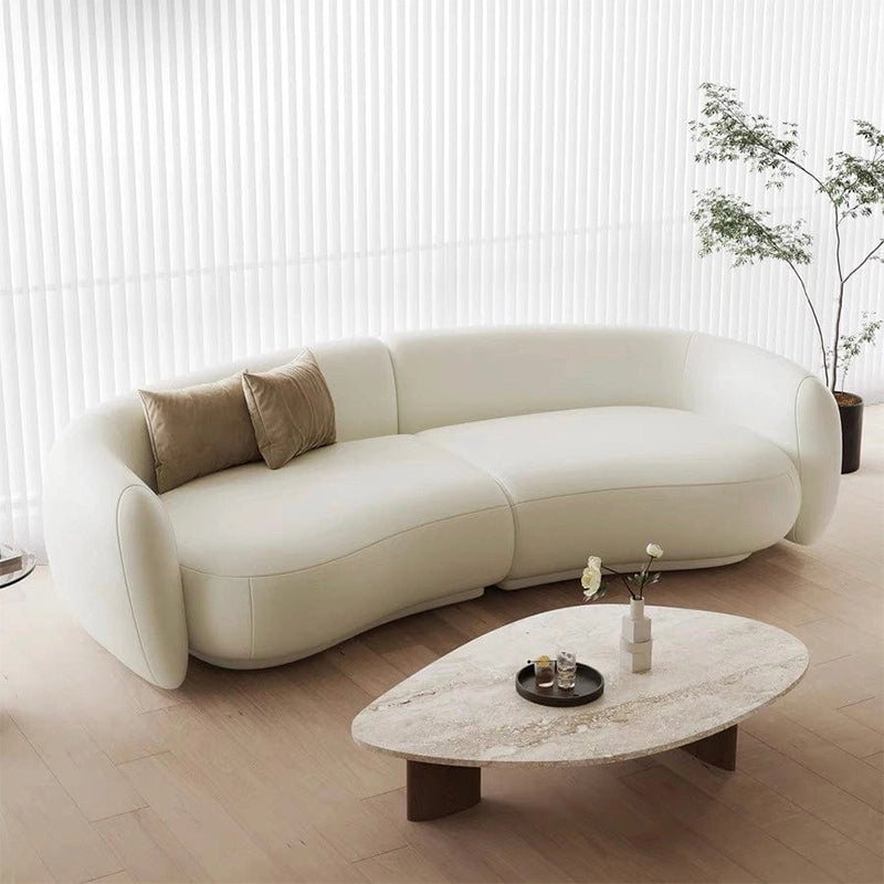 Creamy white kidney sofa designed as a luxury couch and lounge sofa with smooth curves, modern sofa aesthetics, and exceptional comfort for contemporary living rooms.