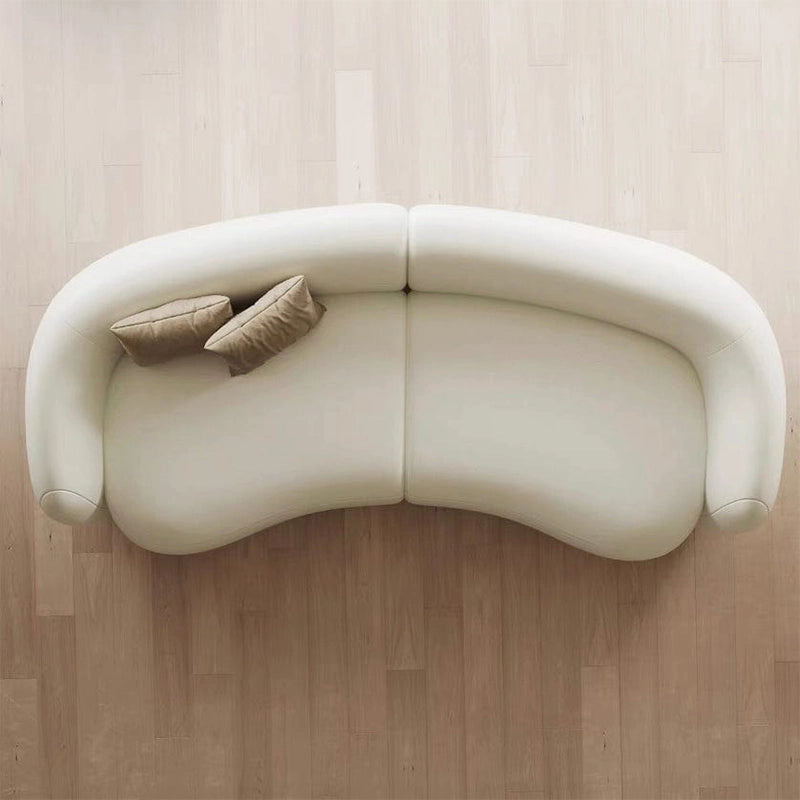 Creamy white kidney sofa featuring luxury sofa craftsmanship, premium leather sofa upholstery, and an elegant sofa design that enhances upscale residential interiors.