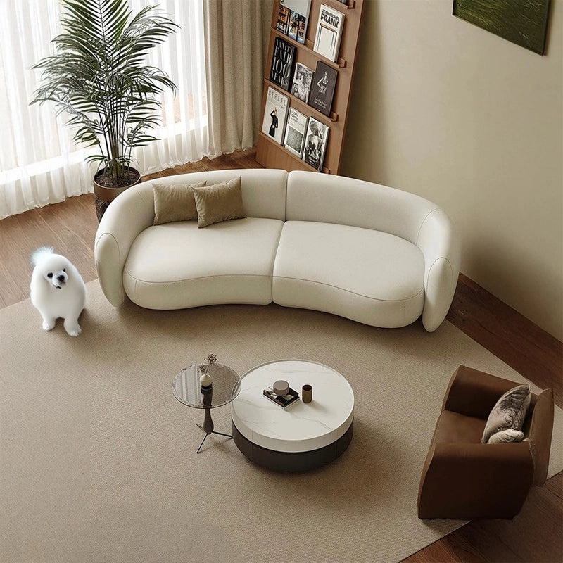 Creamy white kidney sofa showcased as a luxury sofa set and three seater couch featuring a distinctive curved sofa design and contemporary elegance.