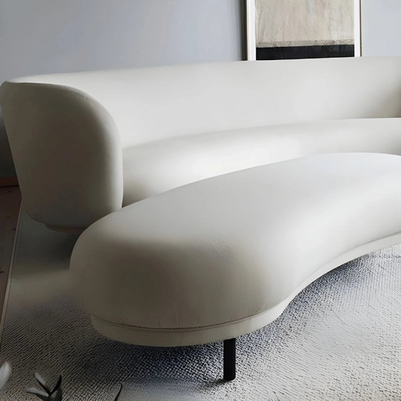 Organic silhouette benches and ottomans in textured upholstery with slender supports