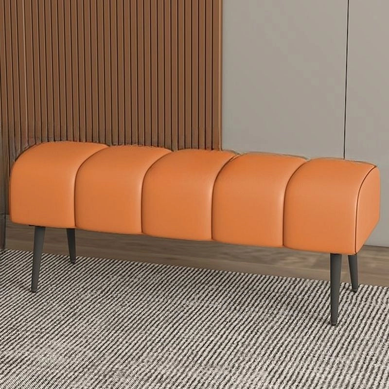 Matte black tapered legs highlight ottoman bench and bench seating form