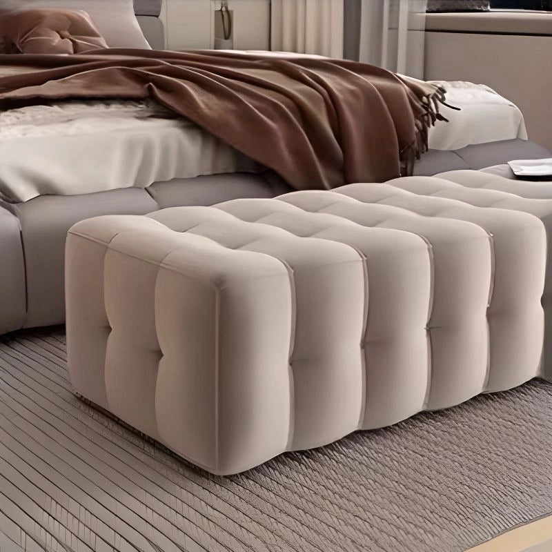 Grounded look of bedroom bench with neutral tones and no visible legs for modern appeal