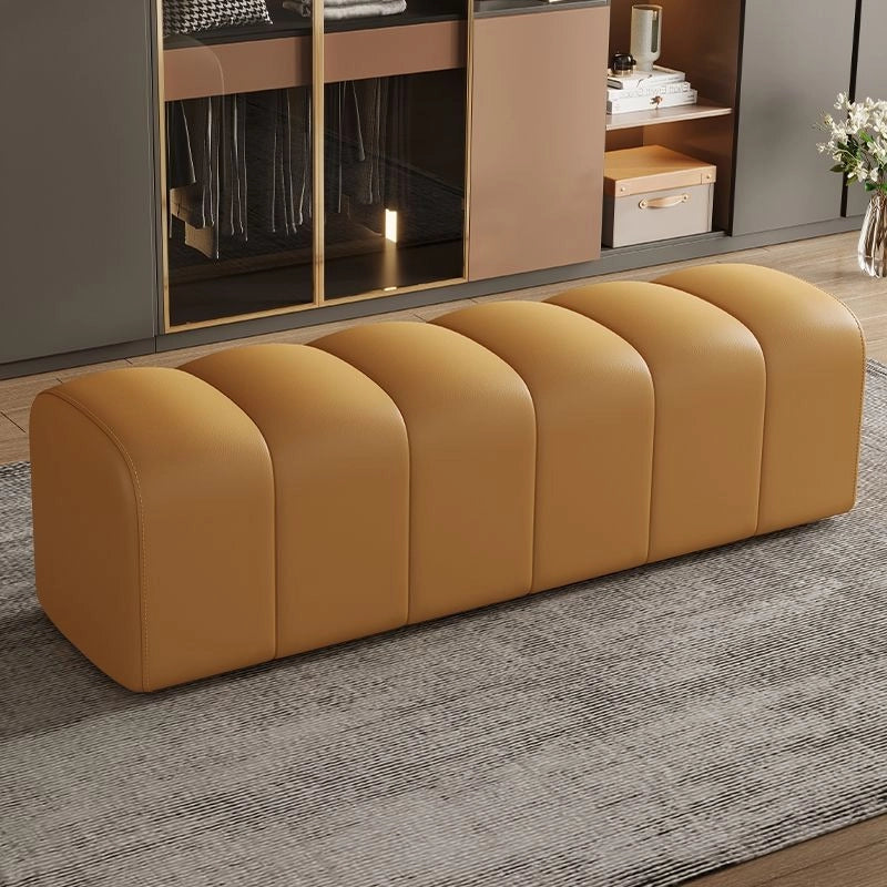 Tan 2 seater bench ottoman with custom crafted upholstery and Art Deco styling