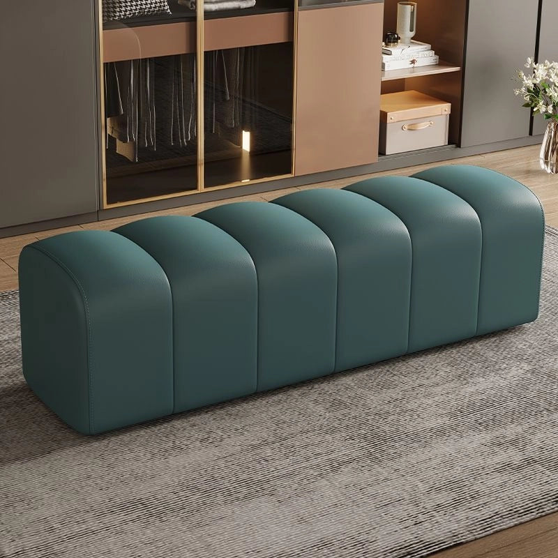 Teal coloured couch bench with plush segments and benches and ottomans visual cue