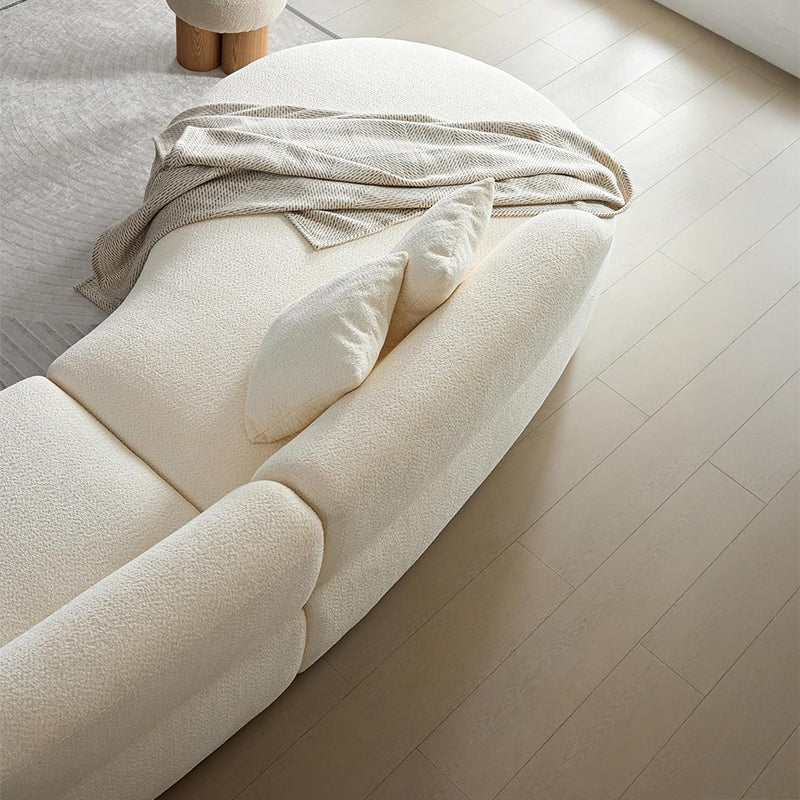 Upholstered in richly textured boucle fabric, it balances visual softness with firm seat support, thanks to high-density foam and an advanced spring system