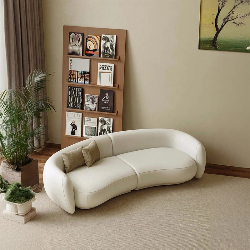 The Synara's curved kidney shape and creamy leatherette upholstery deliver a warm yet minimalist look.