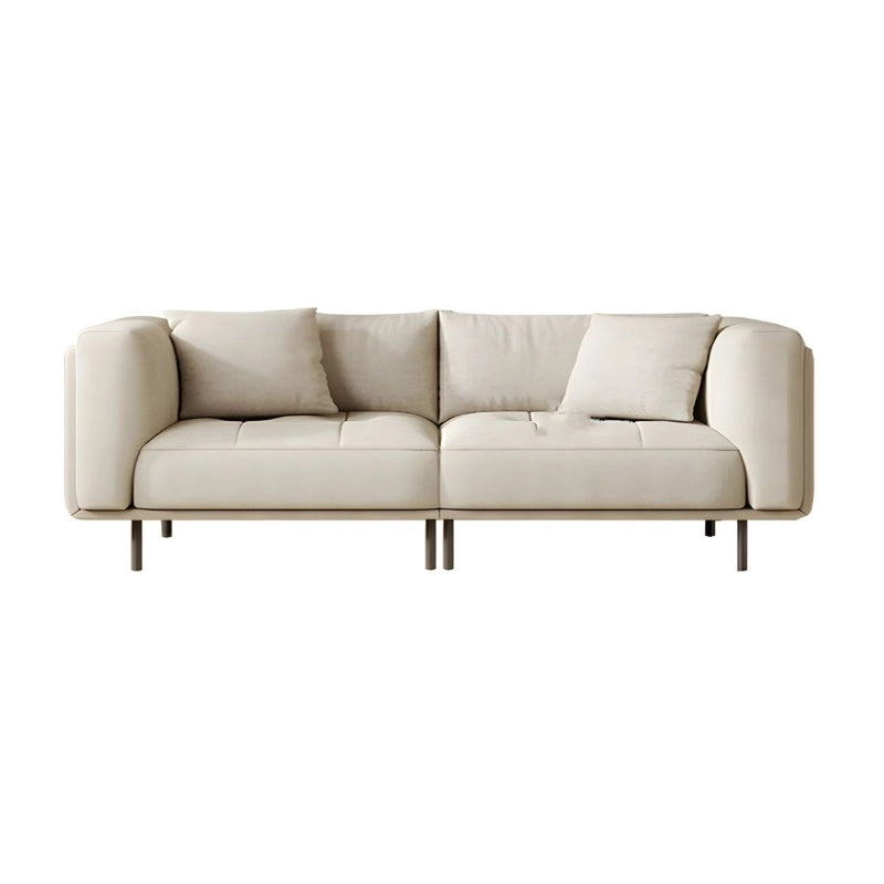 Its creamy beige cloth upholstery complements the airy elevation provided by tall black metal legs.