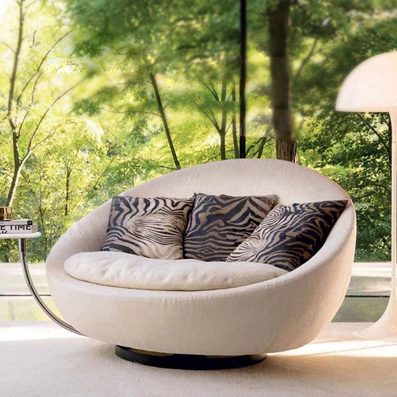 Designed as a sculptural centrepiece, this single seat couch offers velvet-like upholstery in premium shades like ivory, green, and charcoal.