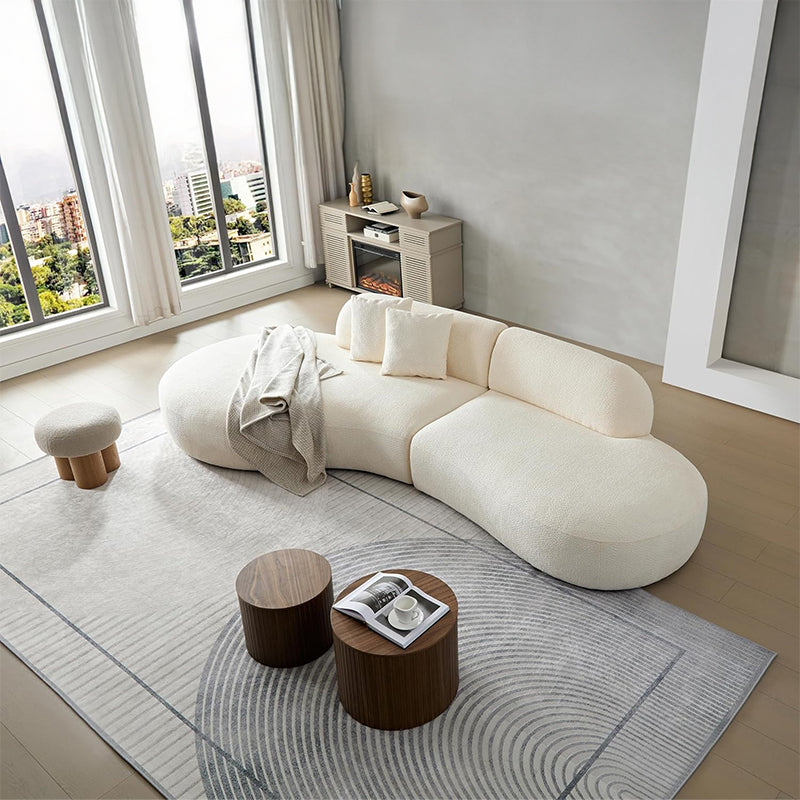 The asymmetric kidney-bean shape and low-profile base give the settee a grounded presence perfect for modern lounge spaces.