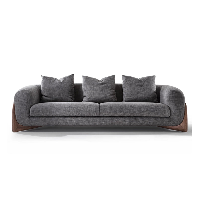 Sculpted natural wood leg inserts add a grounded contrast, supporting its clean silhouette. 