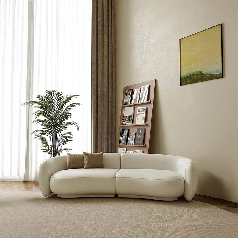 Designed with a wraparound backrest, rounded integrated arms, and recessed base, it offers both ergonomic support and elevated style.