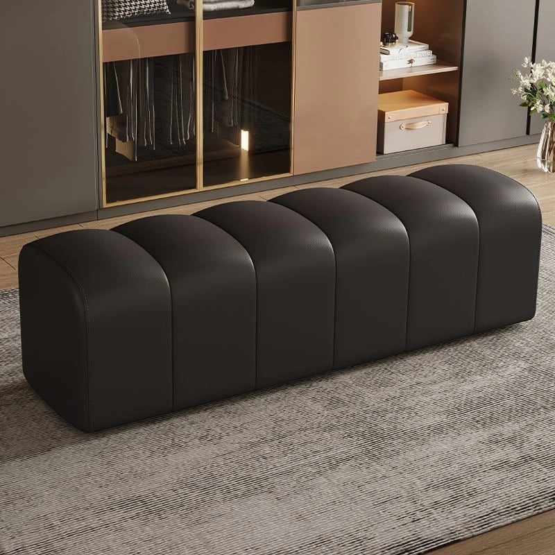 Monochrome black bed bench design with bench ottoman look and sculptural build