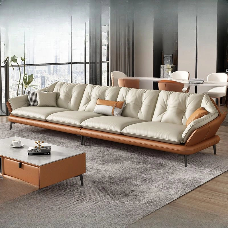 Modern sectional sofa with brown leather and beige cushions in a living room setting.