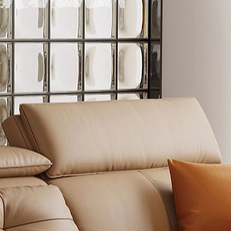 Contemporary convertible sofa bed with broad armrests and tan leatherette look