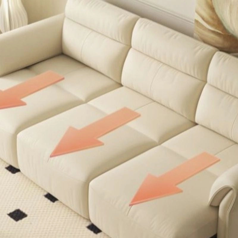Upholstered in neutral cream leatherette, it provides a plush seating experience with supportive medium-firm cushions