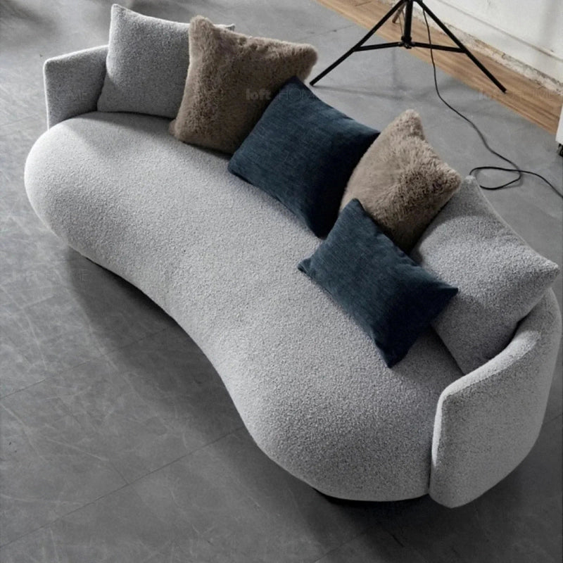 Tale luxury sofa with curved boucle fabric upholstery, designed as a three seater couch and lounge sofa for elegant modern living room interiors.