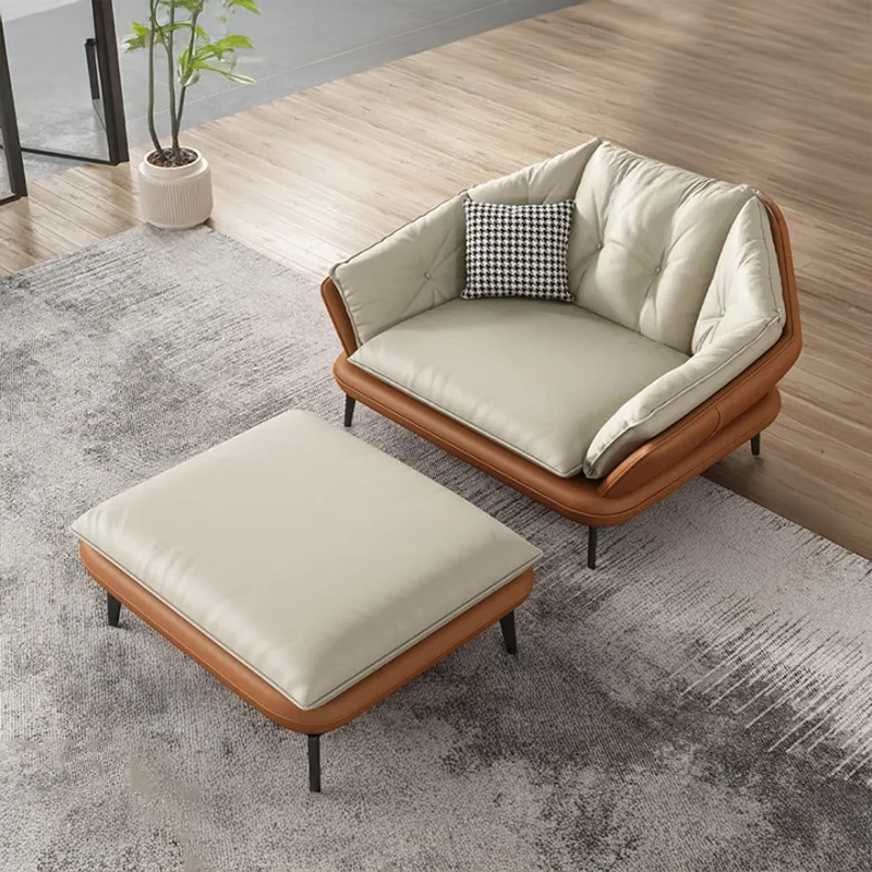 Modern brown and beige 1 seater with matching ottoman on a gray rug.